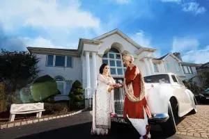 indian wedding couple near the vintage car