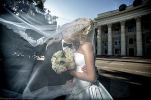 photo of kissing wedding couple near the estate