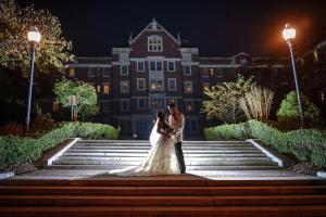 night photo of wedding couple standing on the steps