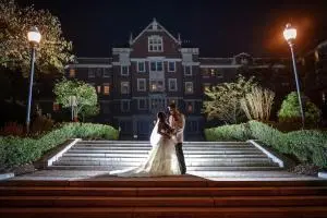 night photo of wedding couple standing on the steps